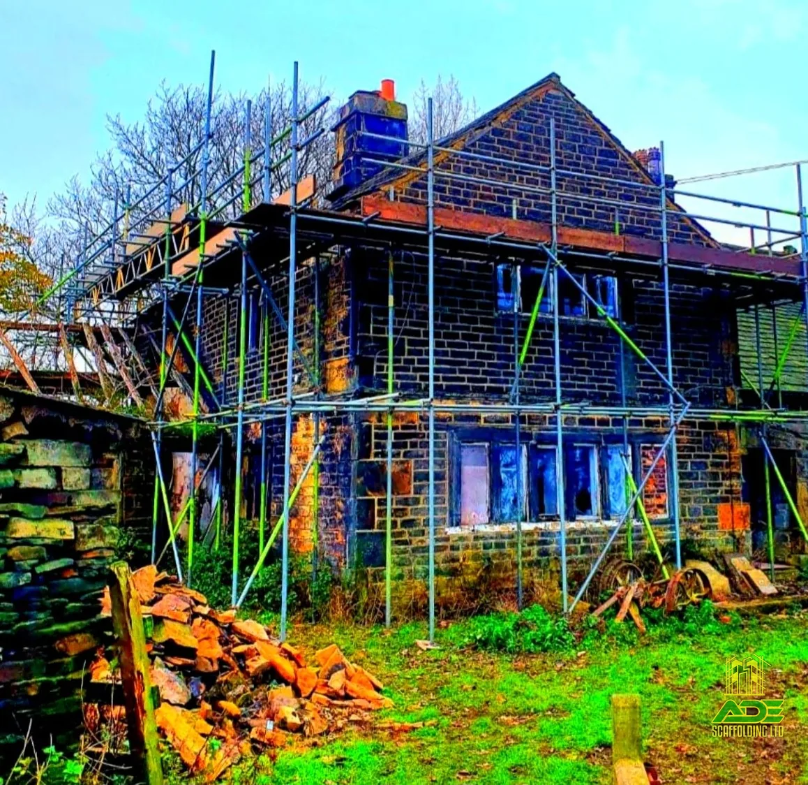 Full wraparound scaffold on a stone farmhouse renovation